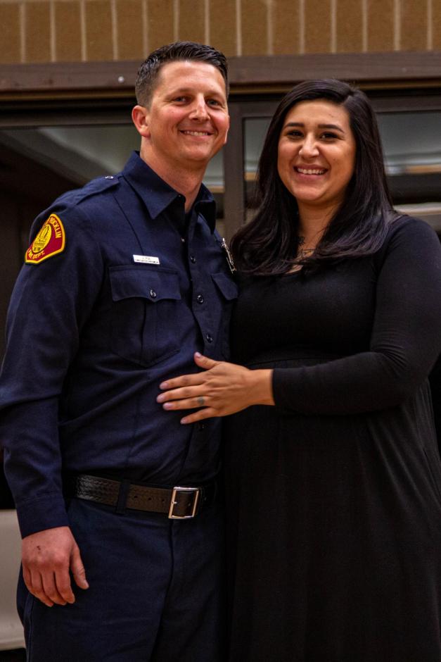 New Rocklin firefighter Jordan Poe smiles with his wife at the hiring ceremony.